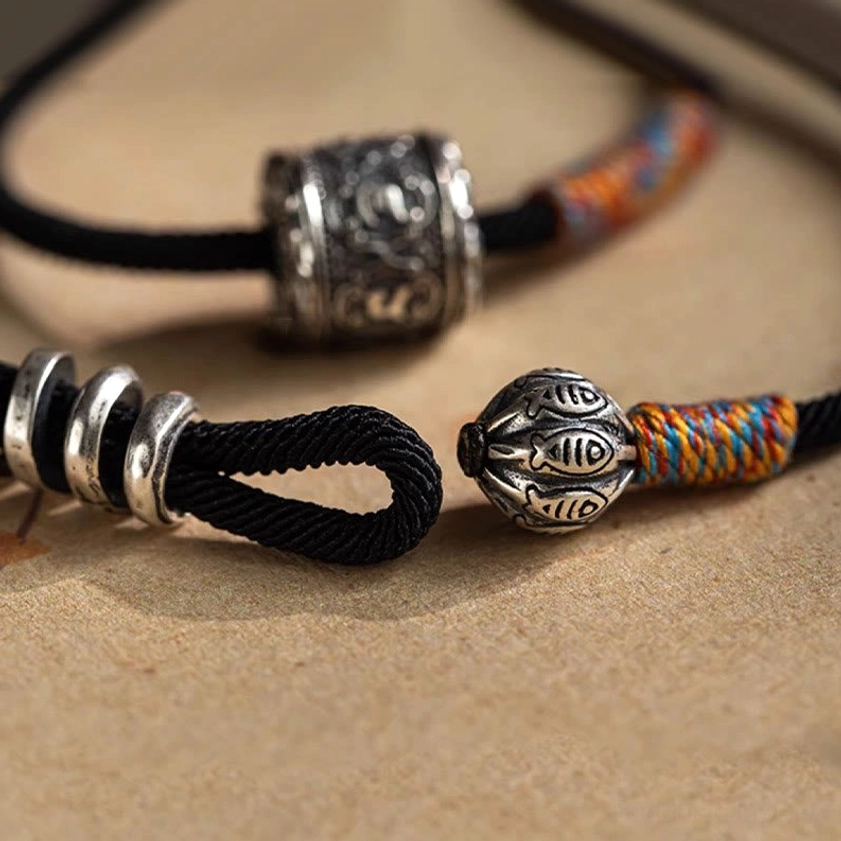 Complete Om Mani Padme Hum double wrap bracelet with silver accents on antique kraft paper background