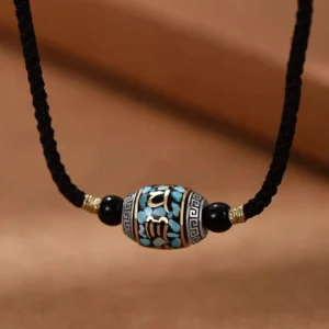 Om Mani Padme Hum Dzi Bead necklace front view with black braided rope and turquoise inlay