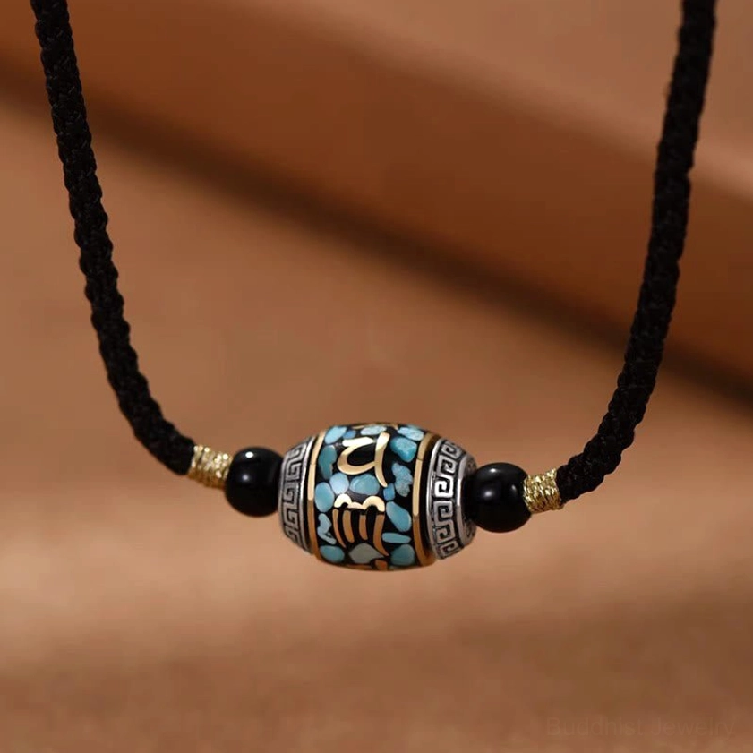 Om Mani Padme Hum Dzi Bead necklace front view with black braided rope and turquoise inlay