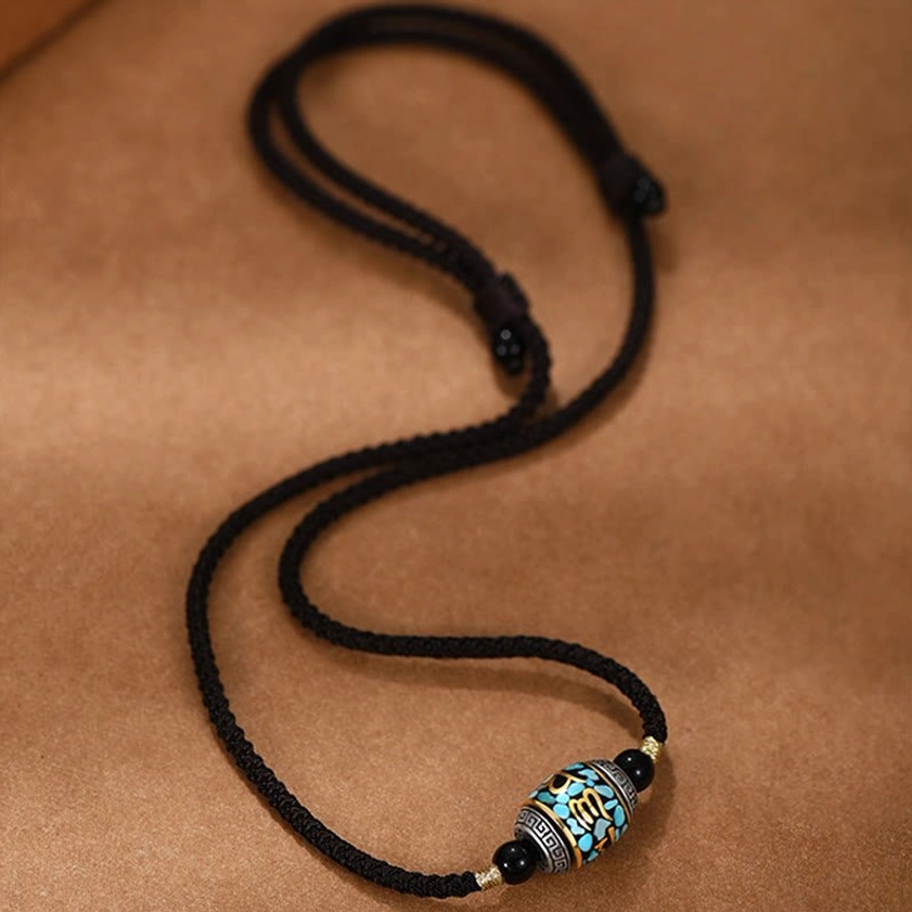 Full length Om Mani Padme Hum Dzi Bead necklace with adjustable rope on suede background