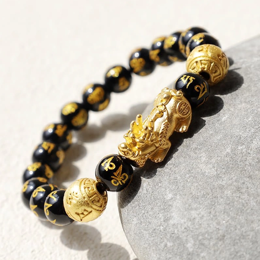 Sacred mantra bracelet featuring engraved Om Mani Padme Hum on natural black obsidian for spiritual meditation practice