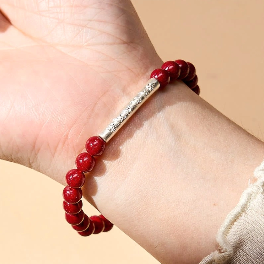 Buddhist spiritual bracelet with six-syllable mantra engraved on sterling silver, surrounded by natural cinnabar prayer beads