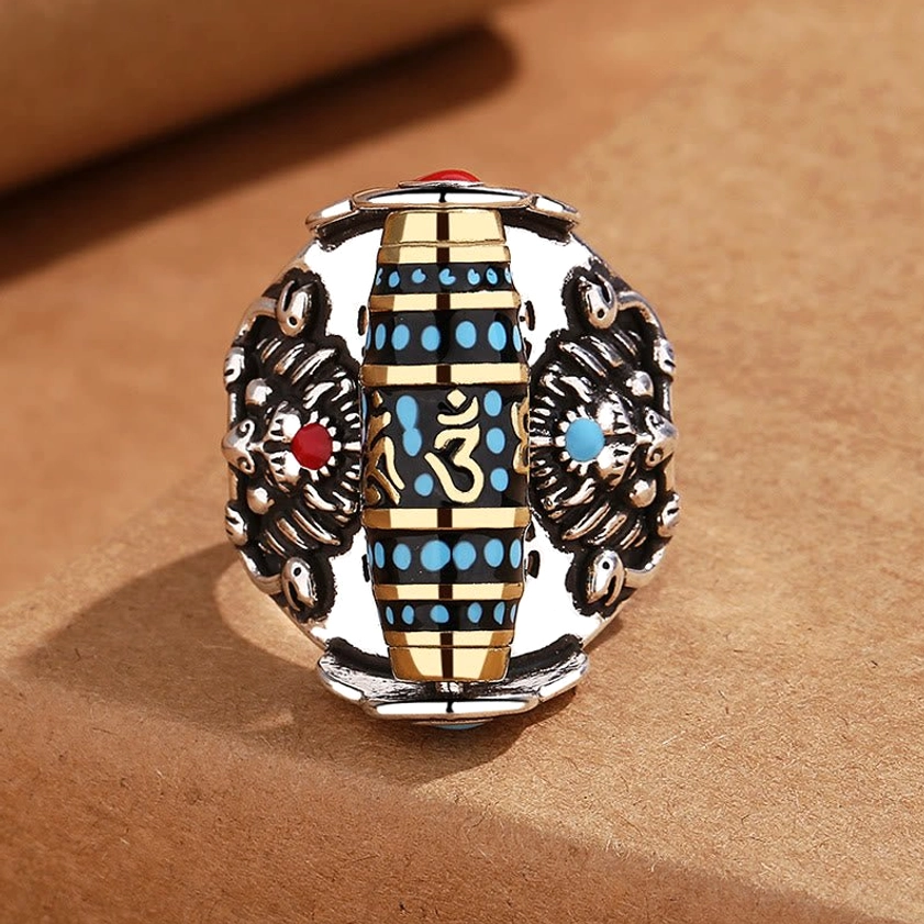 Buddhist Dzi bead mantra ring with dual Garuda carvings and Om symbol, top front view showing intricate details