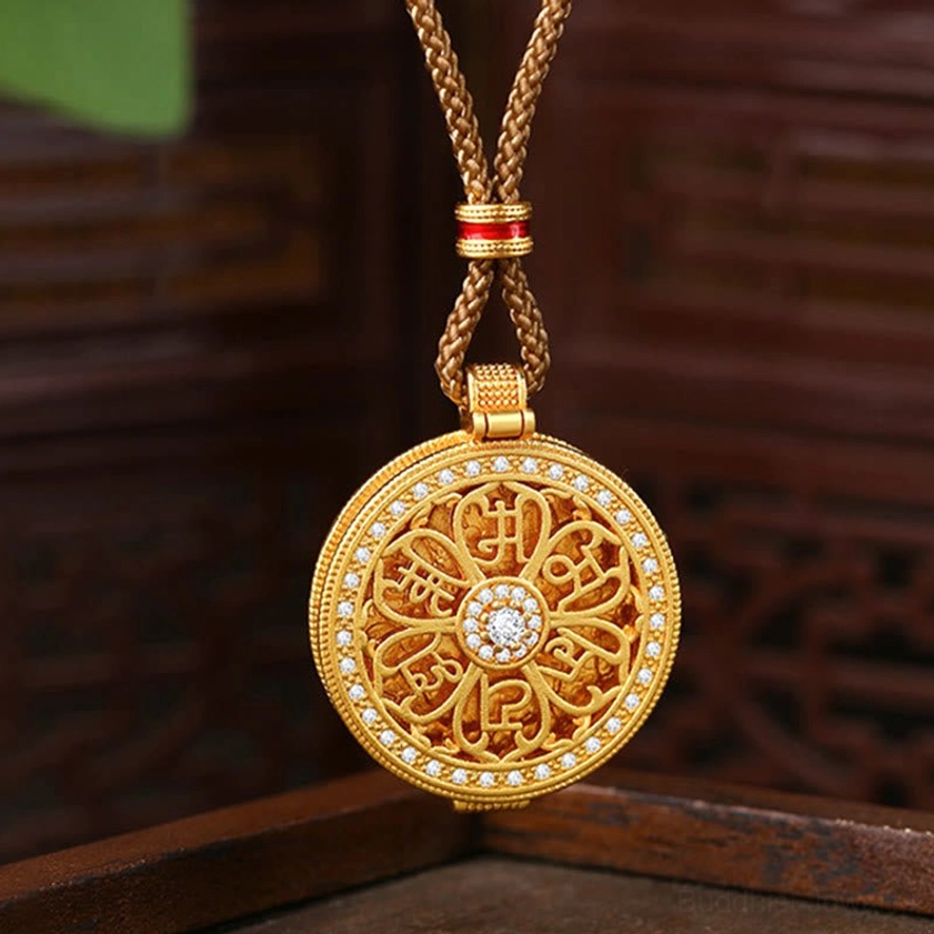 Om Mani Padme Hum openable gold pendant necklace on dark wooden background, showcasing intricate hollowed six-syllable mantra design with cubic zirconia center stone