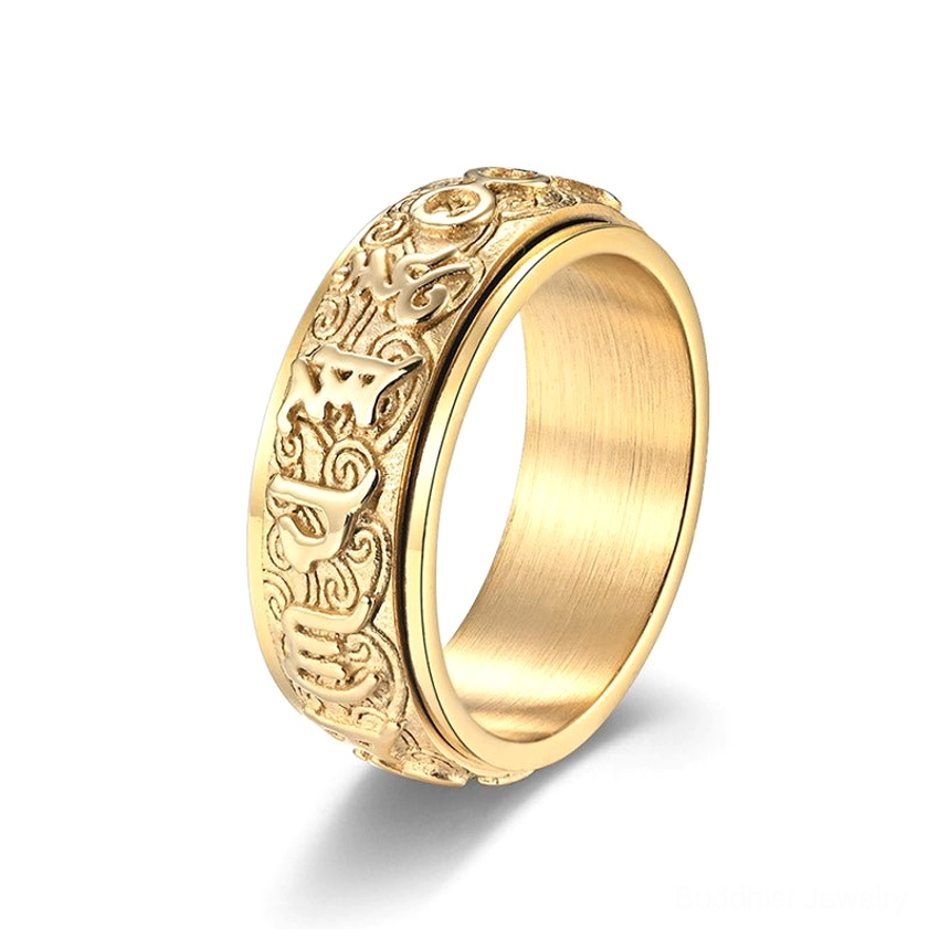 Full gold-plated Buddhist mantra titanium steel ring with wrap-around embossed religious motifs and Sanskrit text, side angle view on white background