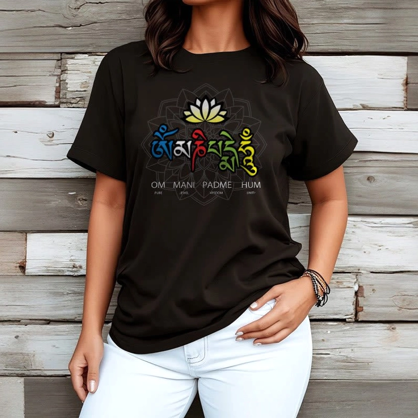 Man wearing black Om Mani Padme Hum lotus graphic tee with crew neck and short sleeves paired with white jeans