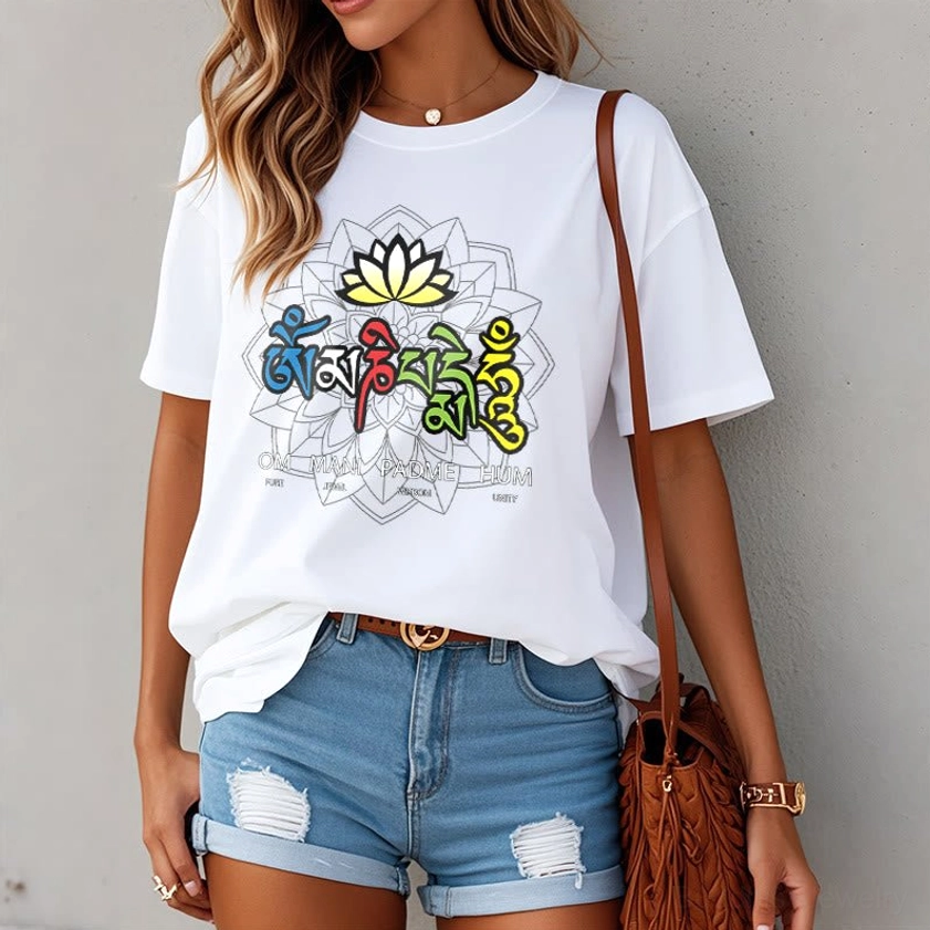 Person wearing white Om Mani Padme Hum lotus graphic tee in oversized casual fit with denim shorts and shoulder bag