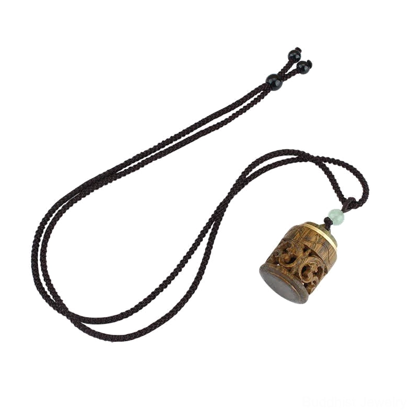 Om Mani Padme Hum mantra carved on green sandalwood Buddhist pendant with copper accents and natural wood patina