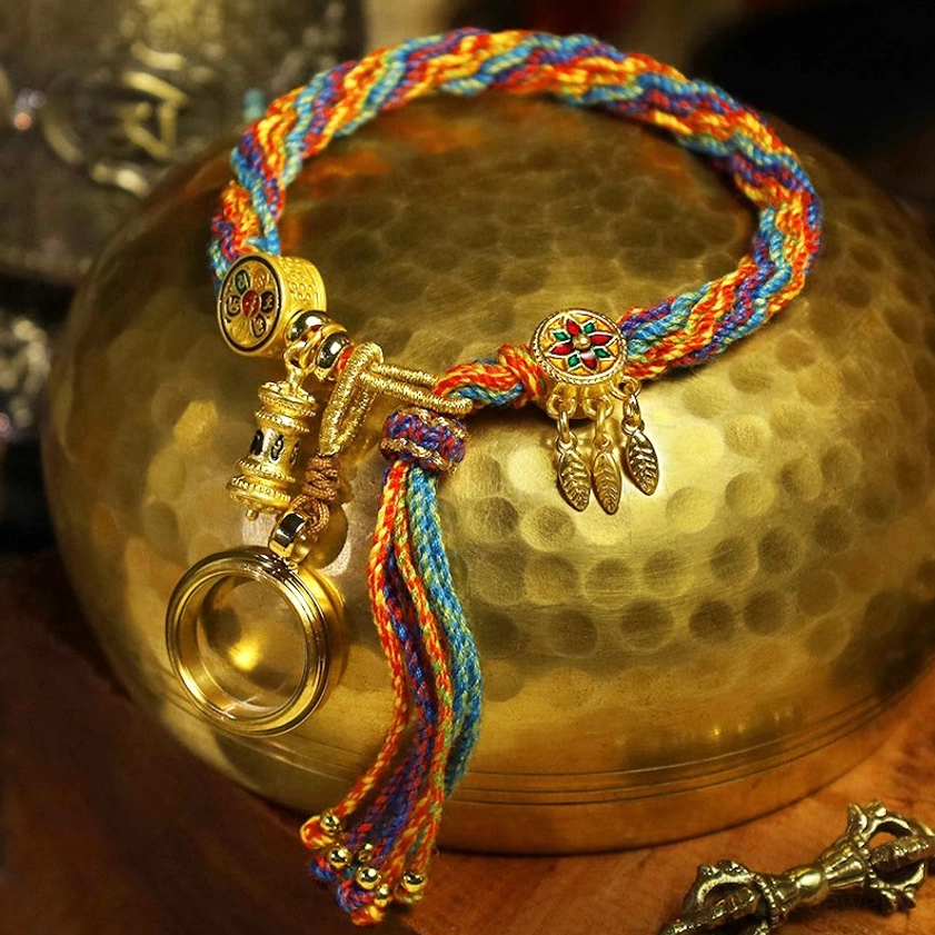 Om Mani Padme Hum Buddhist bracelet with multicolor woven cord and Tibetan-style metal charms on brass bowl