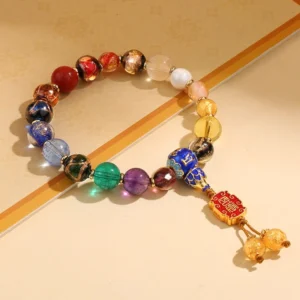 18-bead incense ash liuli glass Buddhist prayer mala bracelet with Om Mani Padme Hum mantra bead and red enamel pendant with golden bell tassels, overhead view