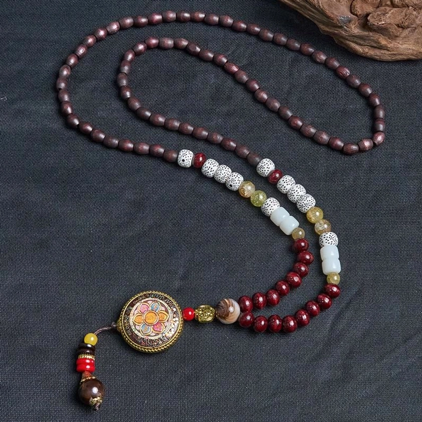 Sacred Buddhist Om Mani Padme Hum wood bead mala necklace overhead flat lay photography