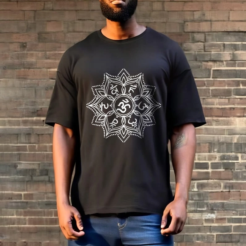 Man wearing black Om Mani Padme Hum Mandala Buddhist T-Shirt with jeans, brick wall background