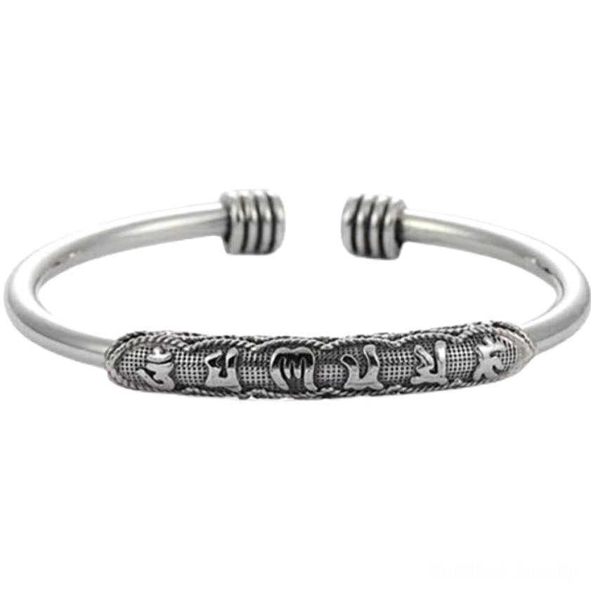 Six-word mantra open cuff bracelet with antiqued silver tone and engraved Buddhist mantras shown flat on white background