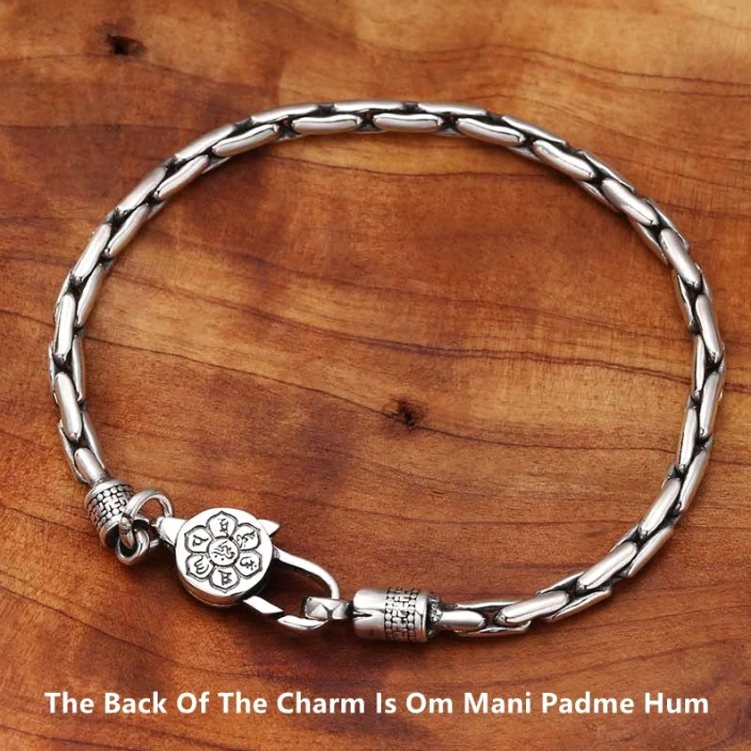 Sacred Om Mani Padme Hum engraved Buddhist bracelet showing mantra charm on linked silver chain