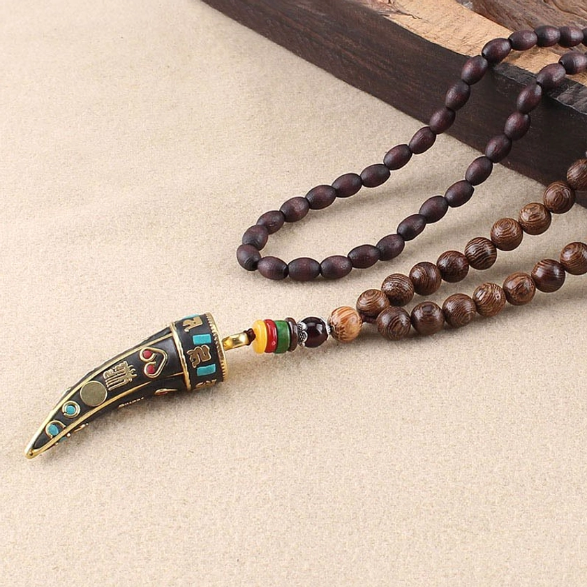 Om mani padme hum buddhist pendant necklace oblique angle showing mantra detail