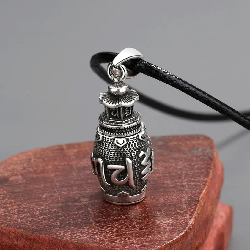 Om Mani Padme Hum necklace pendant side profile close-up, dark silver finish with detailed Sanskrit engraving on leather strap