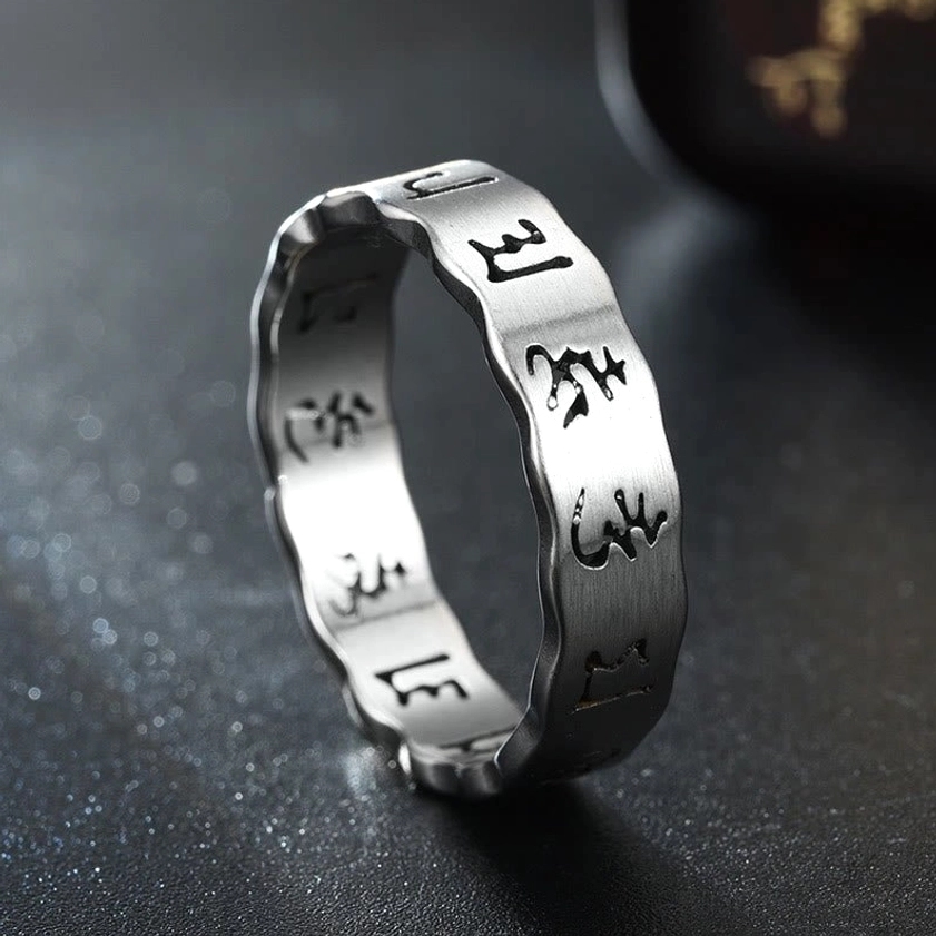 Matte silver om mani padme hum buddhist mantra ring three quarter view with brushed titanium steel texture