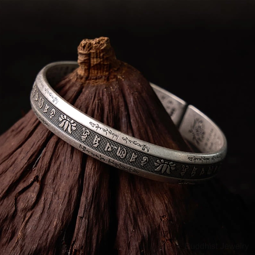 Om Mani Padme Hum Buddhist cuff bracelet showcasing complete mantra engraving and aged silver patina