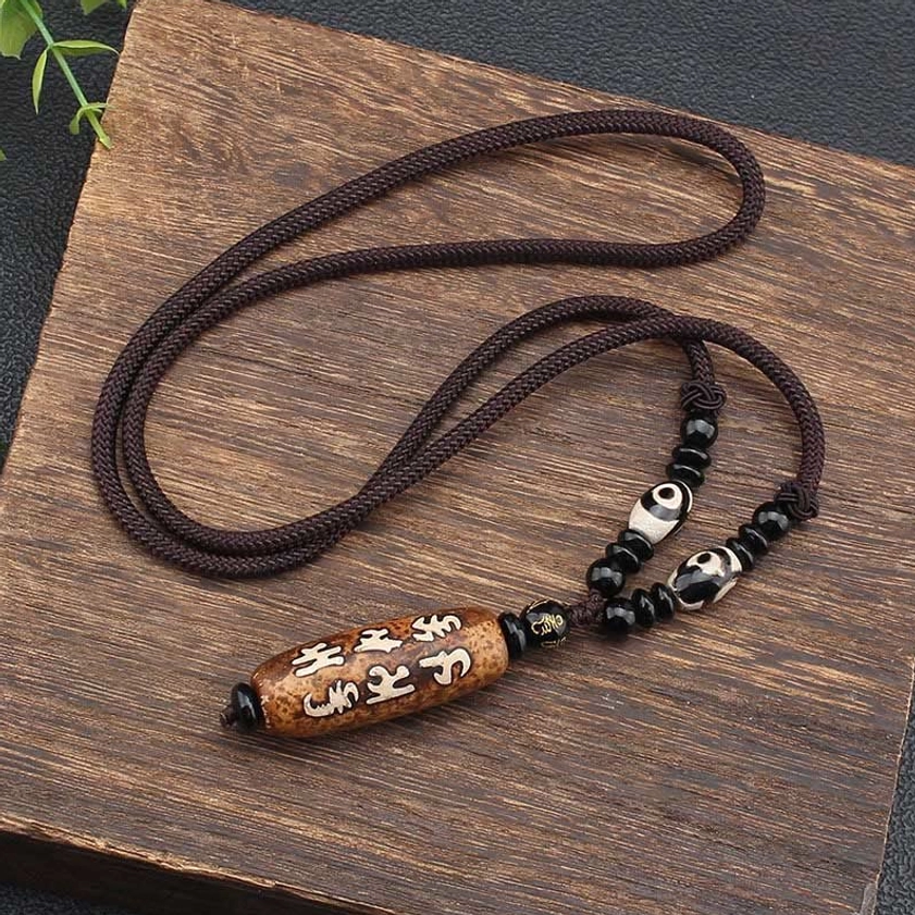 Complete Om Mani Padme Hum Dzi bead Buddhist necklace flat lay showing full length and braided cord