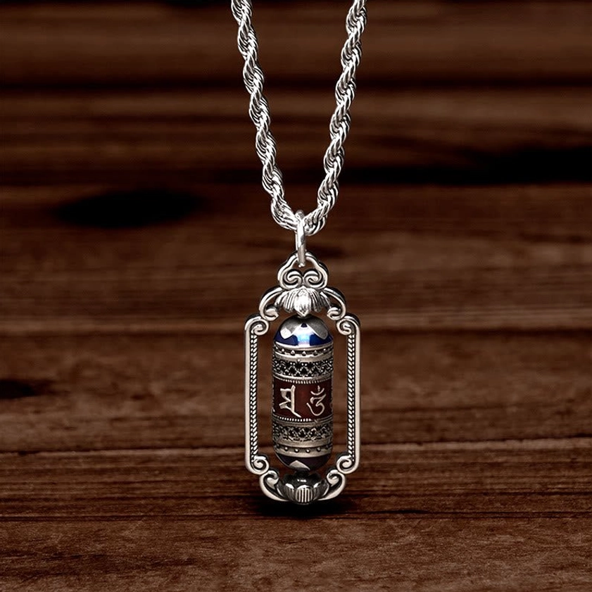 Om Mani Padme Hum copper necklace hanging view displaying prayer wheel pendant on wooden background