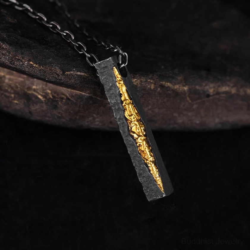 Sacred six syllable mantra Om Mani Padme Hum pendant necklace, oblique side detail showing oxidized black silver with gold carved center