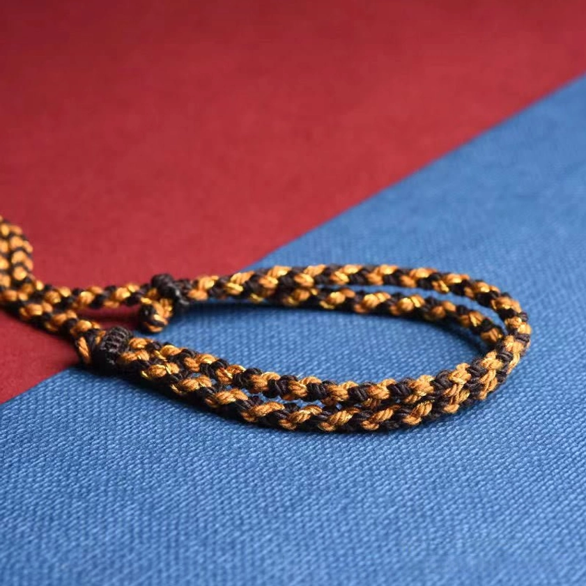 Handmade Buddhist necklace braided rope section showing brown two-tone cord craftsmanship close-up