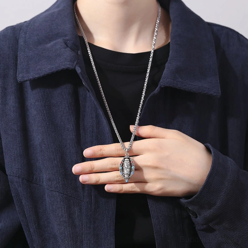 Woman wearing Om Mani Padme Hum Buddhist necklace pendant as daily wear resting at chest with casual clothing demonstration