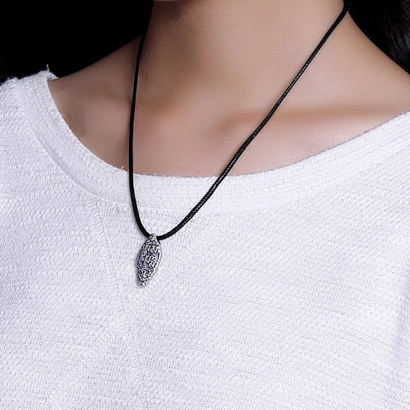 Om Mani Padme Hum Vajra necklace worn on neck, black leather cord with silver pendant on white top, on-body lifestyle wear view