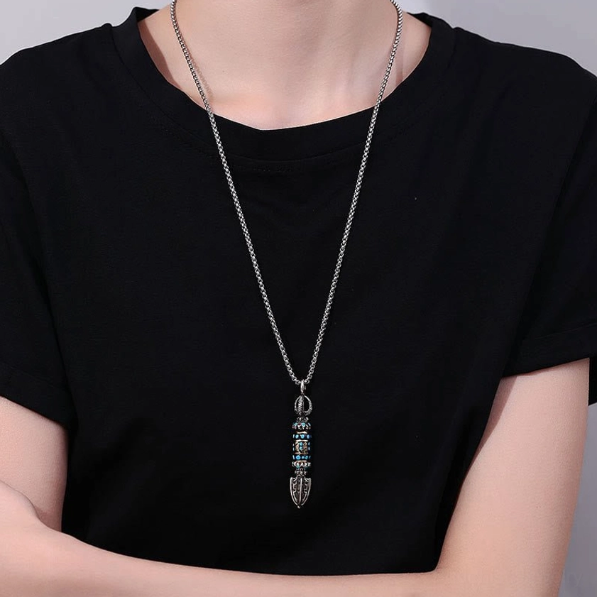 Woman wearing Om Mani Padme Hum Buddhist necklace pendant with wheat chain on black casual t-shirt