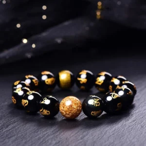 Om Mani Padme Hum Rainbow Obsidian bracelet with gold foil accent bead, featuring hand-etched Sanskrit mantra on polished black beads