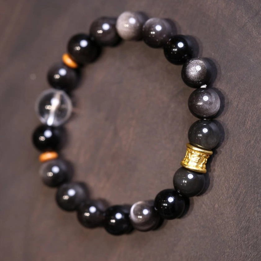 Silver Sheen Obsidian Buddhist bracelet worn on hand showing comfortable fit and silver luster of beads
