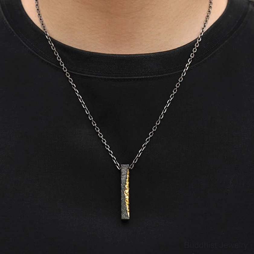 Om Mani Padme Hum necklace pendant worn close to the heart on black t-shirt, styled on neck showcasing proper wearing position for meditation practice