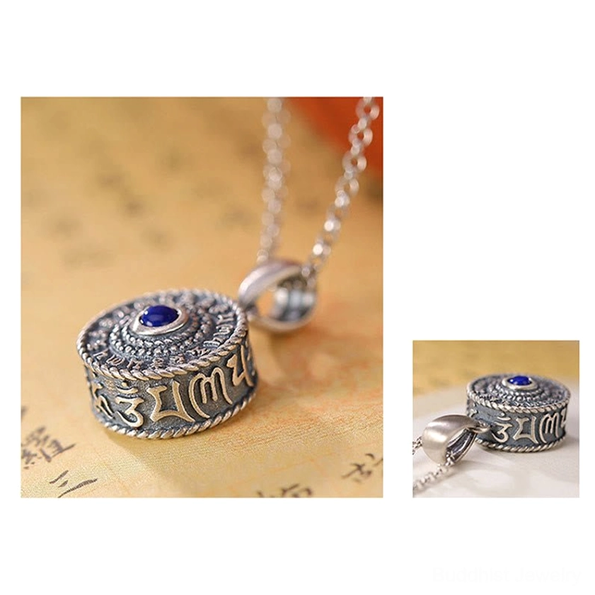 Overhead view of Om Mani Padme Hum round silver pendant with full sutra inscription and lapis lazuli center stone on vintage Buddhist scripture