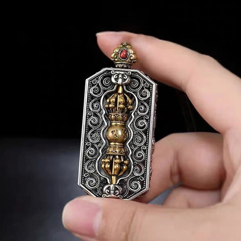 Side view of carved om mani padme hum dorje pendant showing dual-tone metal and rotatable center detail