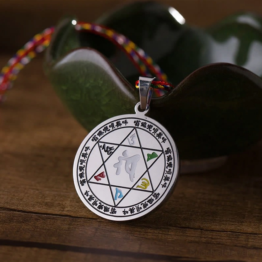 Om Mani Padme Hum necklace pendant side view showing circular Sanskrit mantra engravings