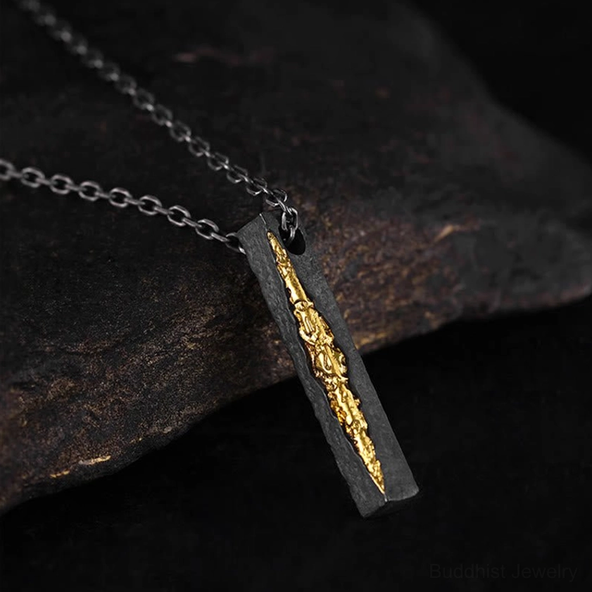 Buddhist Om Mani Padme Hum necklace pendant on silver chain, 3/4 side angle view showing intricate gold inlay mantra work