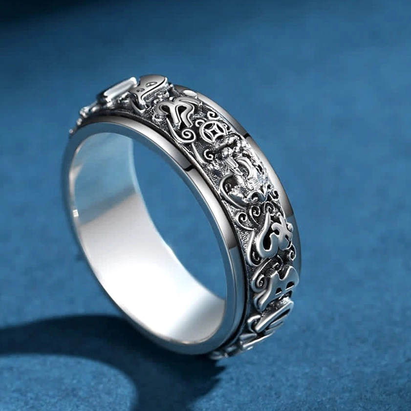 Om Mani Padme Hum rotatable meditation ring featuring detailed sutra and Pixiu carvings, three-quarter view highlighting the rotating outer band with protective symbols
