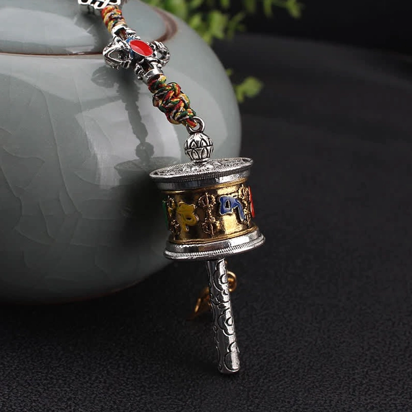 Om Mani Padme Hum prayer wheel mini hanging decor with gold-silver dual tone, engraved six-word mantra, and carved metal handle
