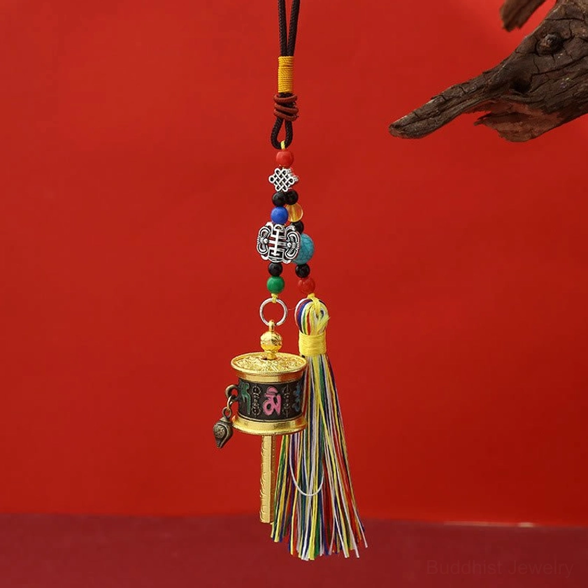 Black antique bronze Om Mani Padme Hum prayer wheel keychain with darkened metal finish and vibrant tassels