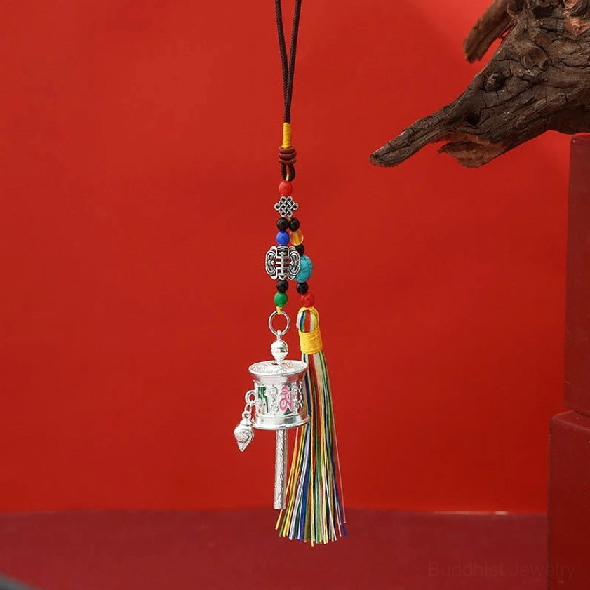 Matte silver Om Mani Padme Hum prayer wheel keychain with vibrant colorful tassels hanging decoration