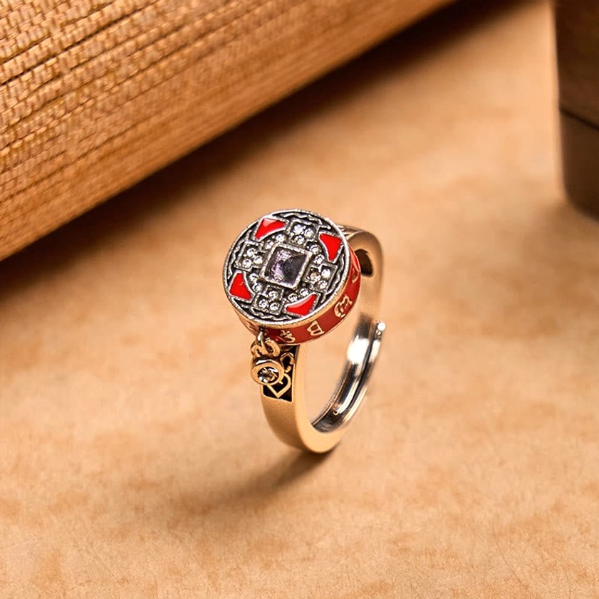 Om Mani Padme Hum rotatable copper prayer wheel ring with red enamel, front overhead view showing engraved mantra and crystal inlays