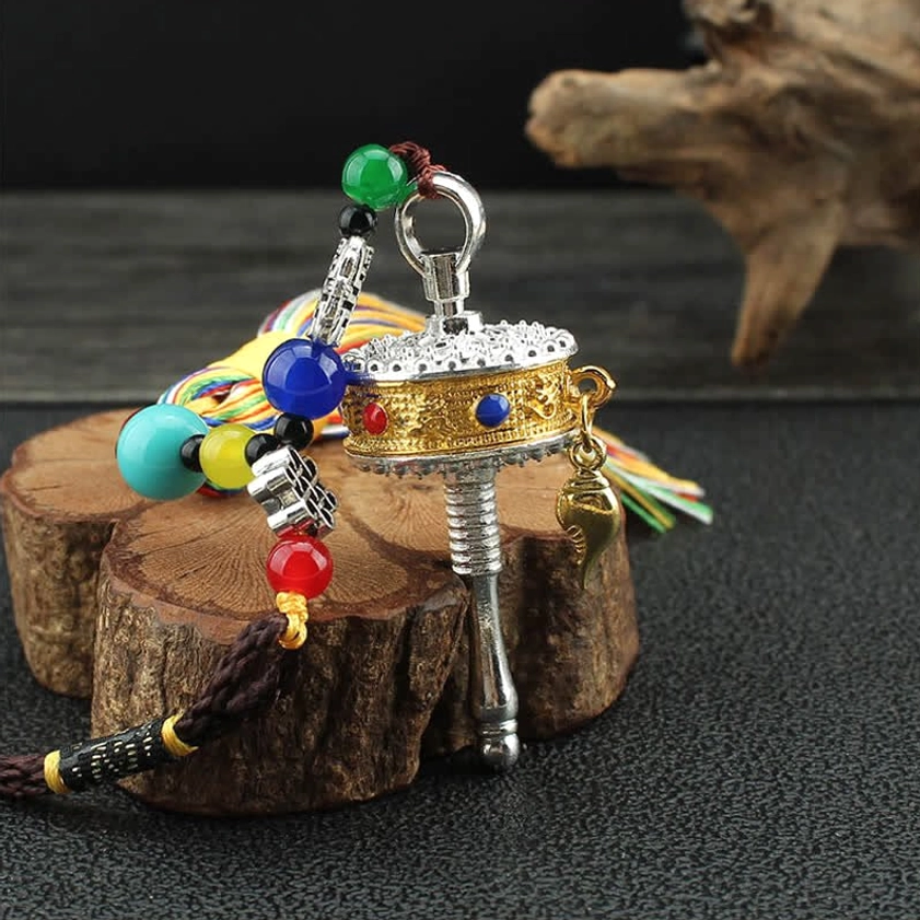 Om Mani Padme Hum sacred mantra prayer wheel with rainbow tassel Buddhist ornament