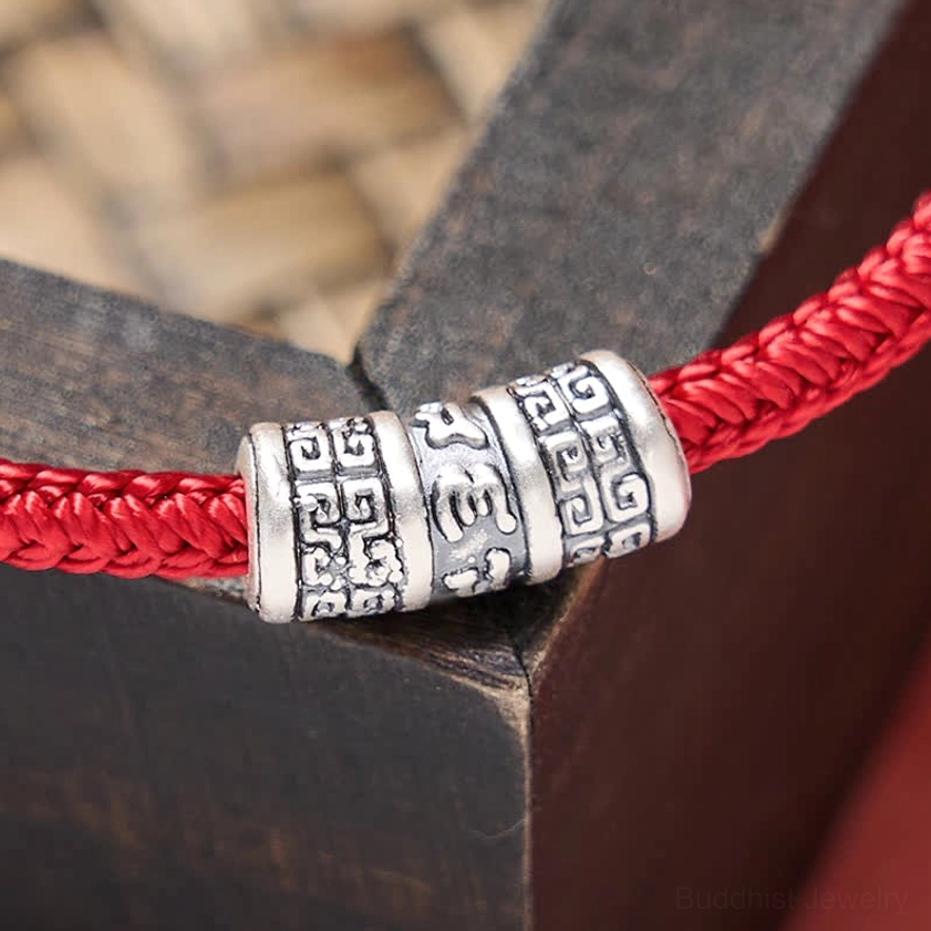 Om Mani Padme Hum red string Buddhist bracelet meditation and mindfulness practice promotional image