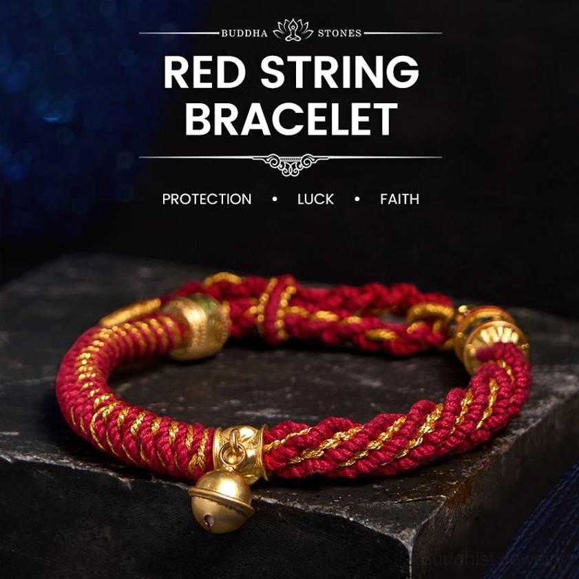 Red gold Buddhist string bracelet with sacred mantra charm and protective amulet on display