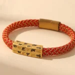 Om Mani Padme Hum red gold braided Buddhist blessing bracelet with diamond knot clasp top view