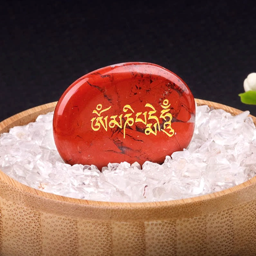 Om Mani Padme Hum red jasper palm stone with golden engraving in wooden bowl