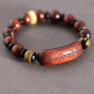 Red sandalwood Om Mani Padme Hum bracelet with engraved mantra bead overhead view