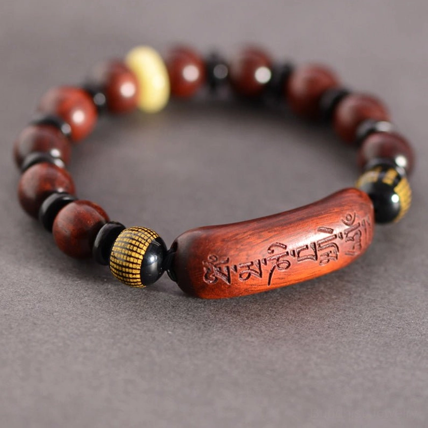 Red sandalwood Om Mani Padme Hum bracelet with engraved mantra bead overhead view