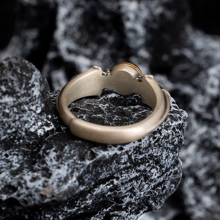Om Mani Padme Hum sterling silver ring rear view showing open adjustable band structure on stone background