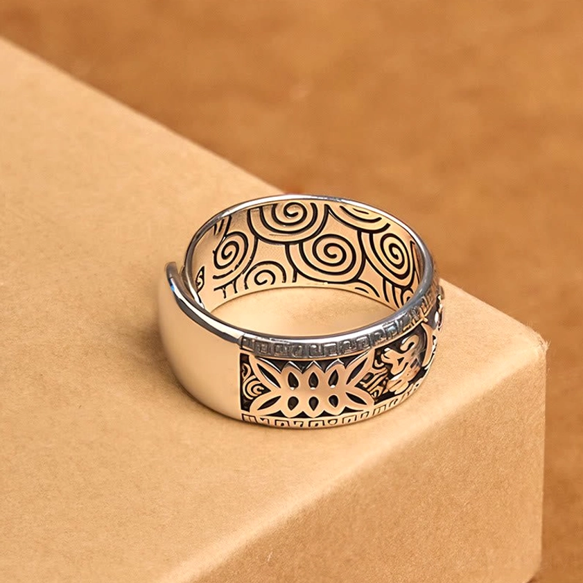Copper Buddhist mantra ring side view showing spiral hollow inner design and embossed outer patterns